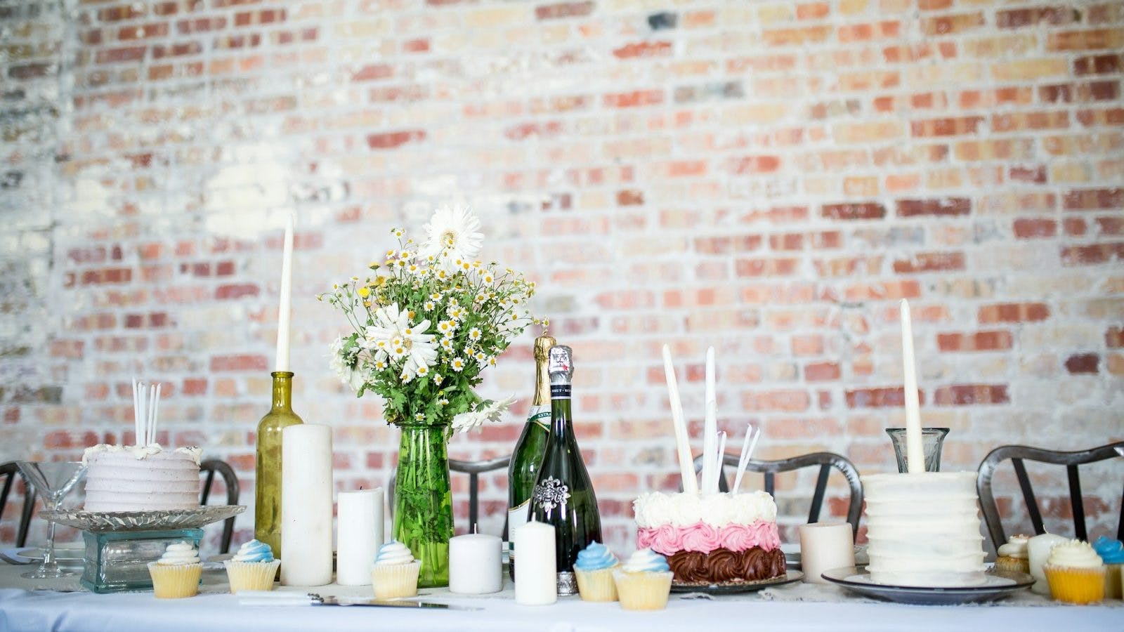 cake beside candles and flowers
