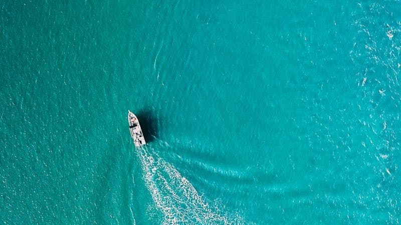Drone view of yacht sailing in sea water