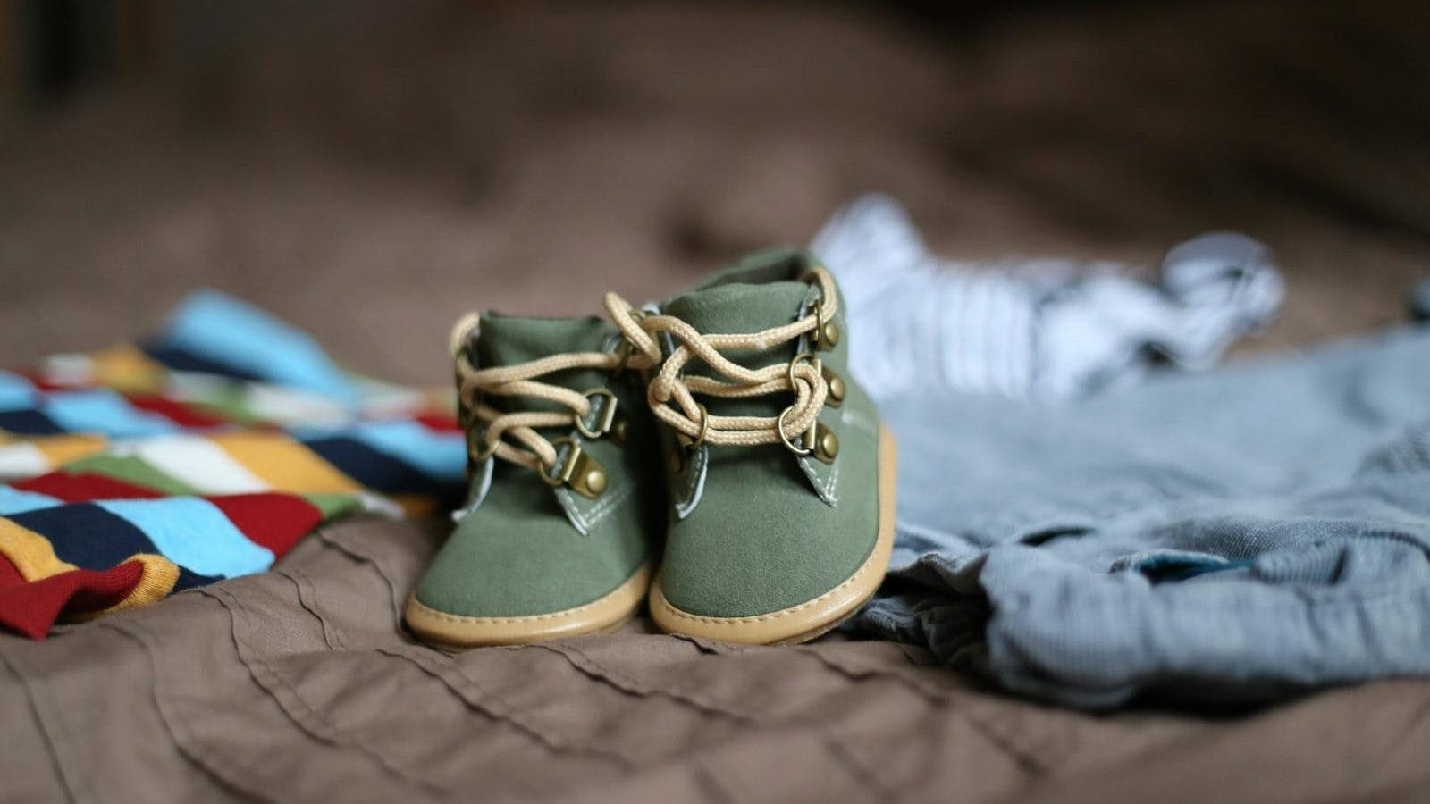 Baby's Green and Beige Sneakers on Brown Textile