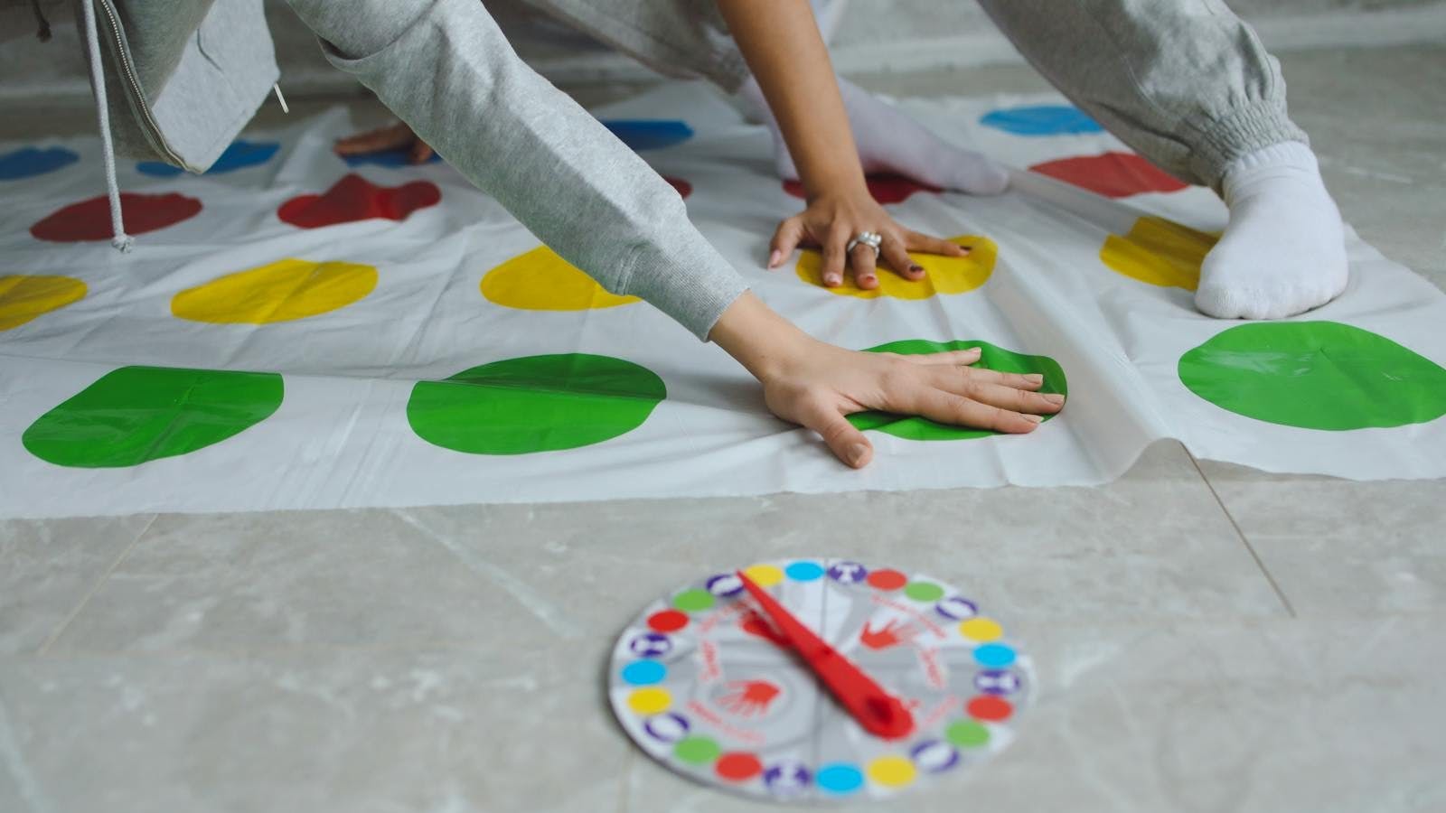 Hands on Persons on a Twister Mat