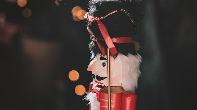 red and black nutcracker figurine in closeup photo