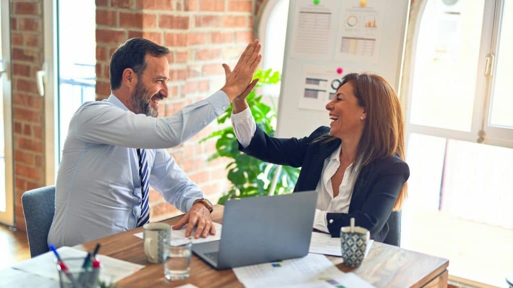 man in white dress shirt sitting beside woman in black long sleeve shirt