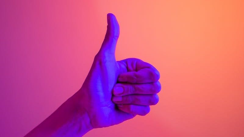 Persons Hand Doing Thumbs Up
