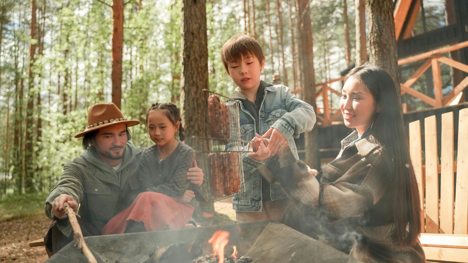 A Family Grilling Food on Bonfire