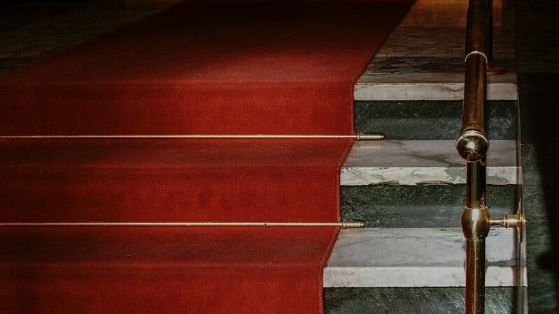 red concrete staircase with stainless steel railings