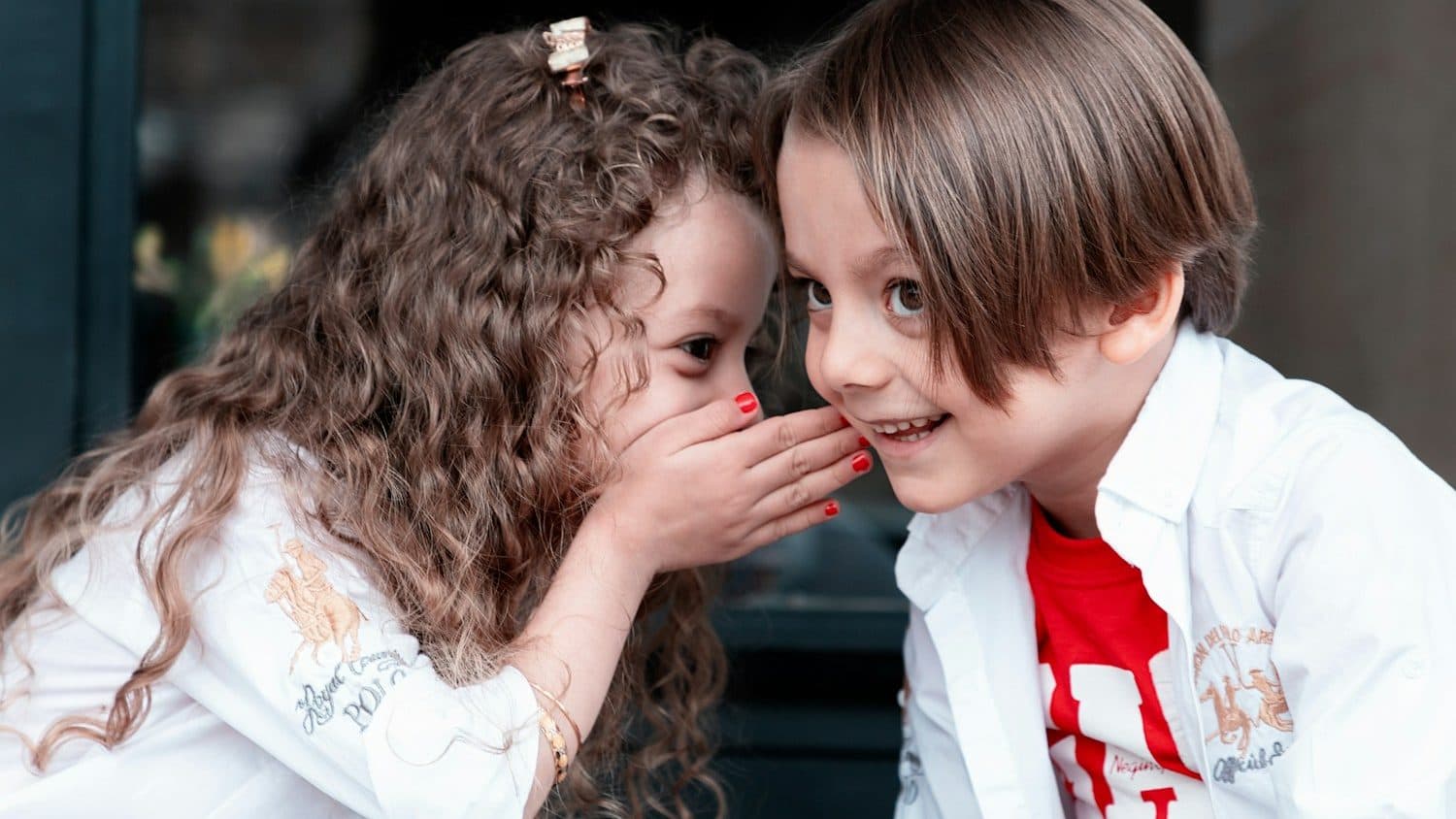 woman in white long sleeve shirt kissing girl in white long sleeve shirt