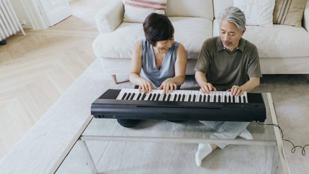 a man and a woman playing a piano on a couch