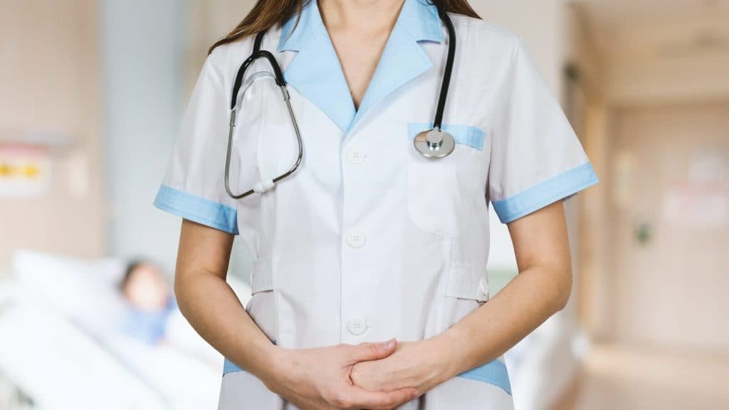 woman in white button up shirt and blue stethoscope
