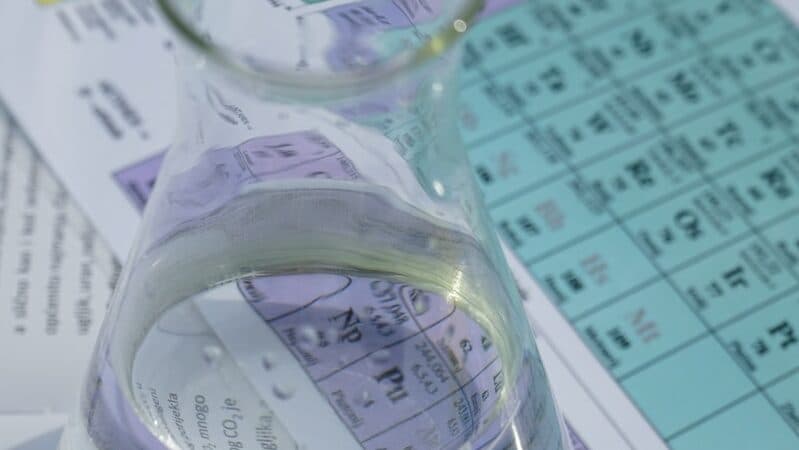 clear glass pitcher on white paper