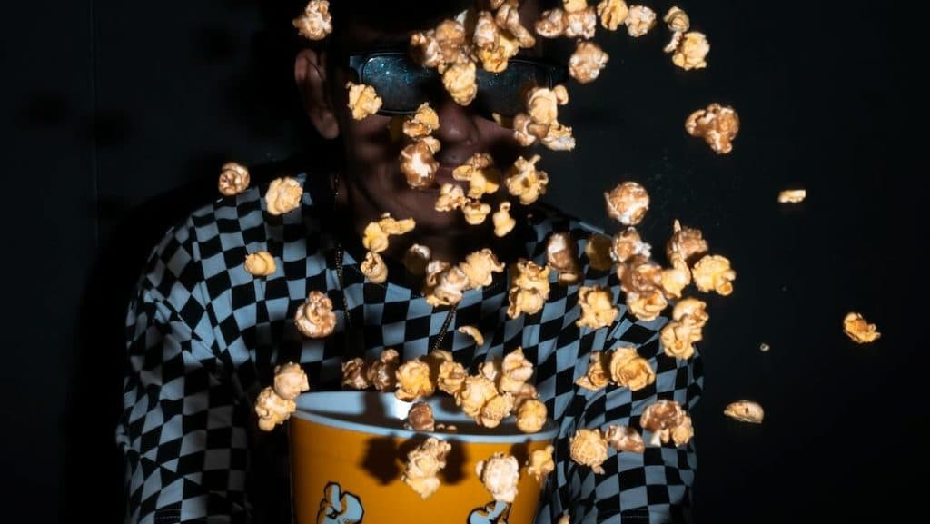 woman in blue and white polka dot shirt holding yellow ceramic mug