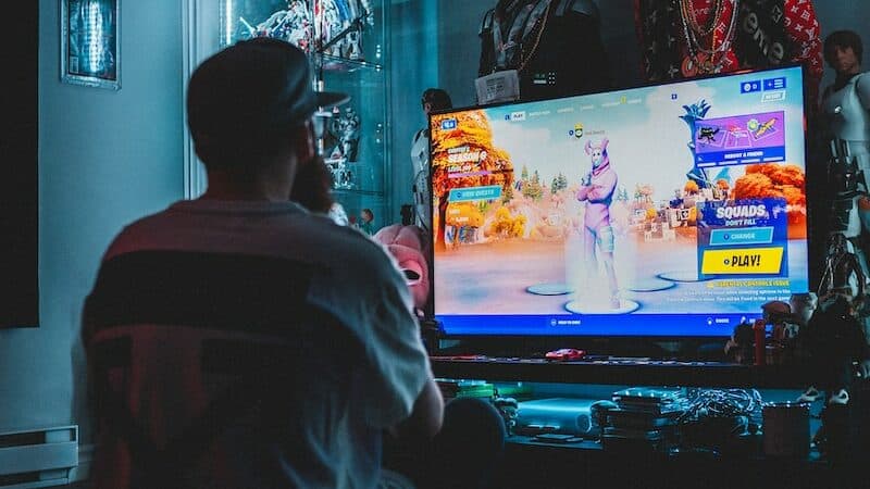 man in red shirt watching tv