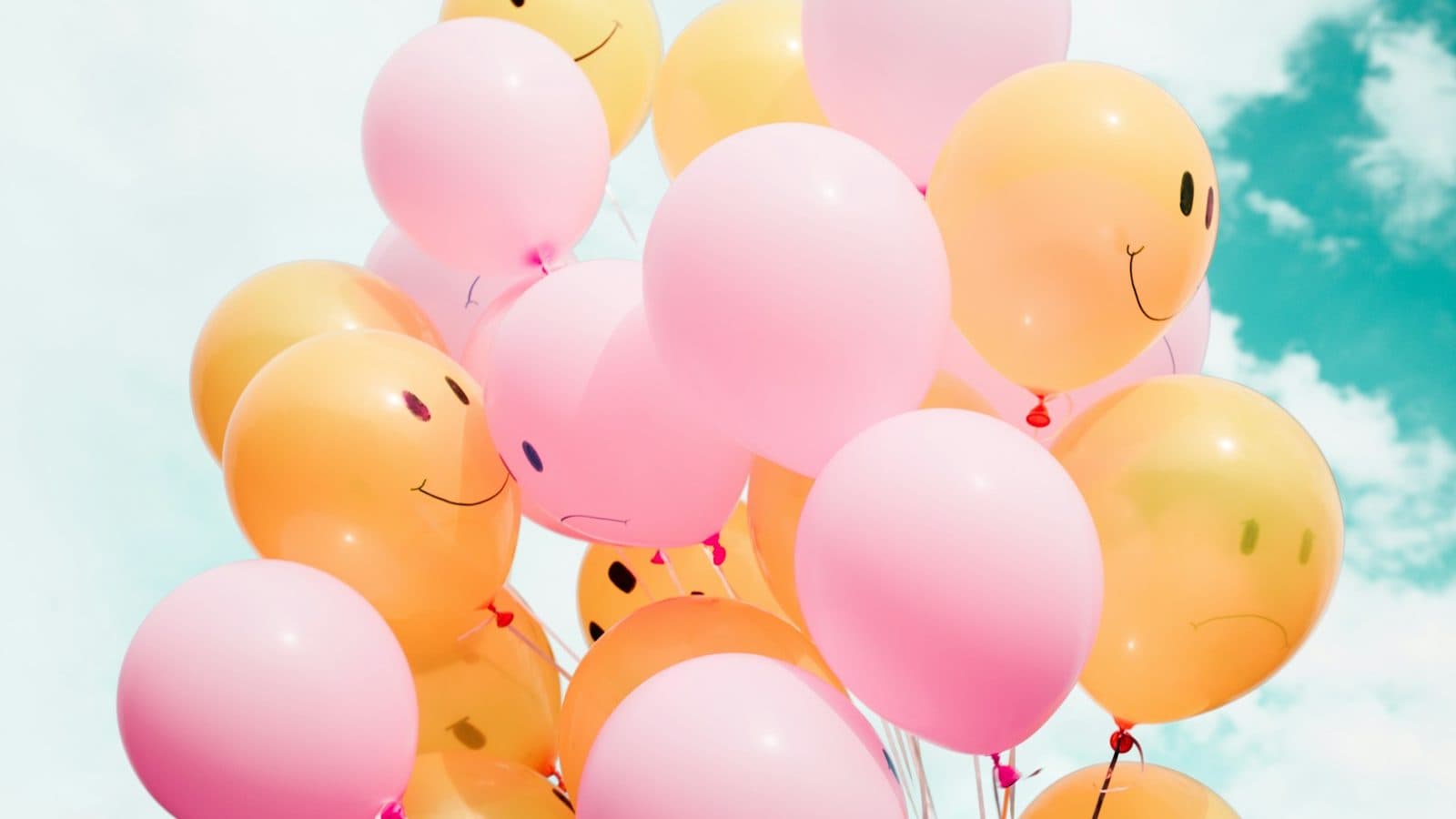 low-angle photo of pink and orange balloons