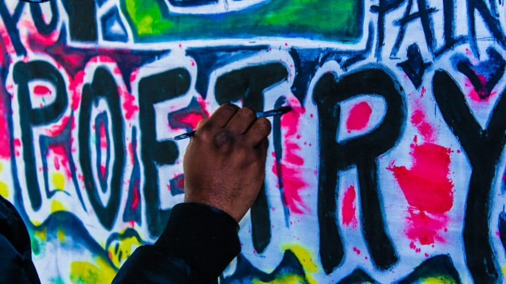 person doing wall graffiti