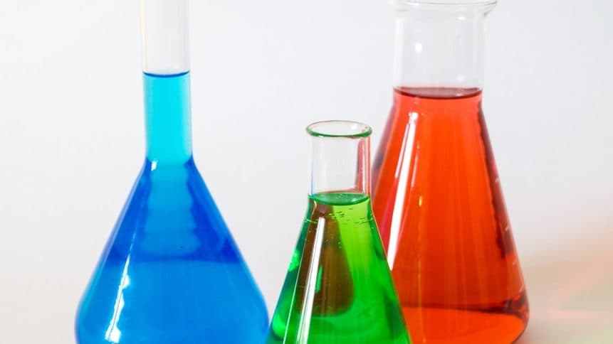 three assorted-color liquid-filled laboratory apparatuses